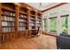 Spacious library with built-in wooden bookshelves and a large window offering abundant natural light at 3499 Rockcliff Pl, Longwood, FL 32779