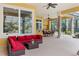 Spacious patio with red sectional sofa and outdoor kitchen at 3499 Rockcliff Pl, Longwood, FL 32779