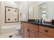 Clean bathroom with granite vanity, tiled shower, and decorative accents at 3499 Rockcliff Pl, Longwood, FL 32779