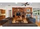 Spacious living room with built-in shelving and fireplace, hardwood floors and leather sofas at 3499 Rockcliff Pl, Longwood, FL 32779