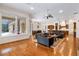 Spacious living room with hardwood floors, comfortable seating, and large windows at 3499 Rockcliff Pl, Longwood, FL 32779