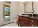 Bathroom with dark wood vanity, granite countertop, and access to backyard pool at 3499 Rockcliff Pl, Longwood, FL 32779