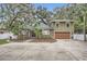 Two-story house with a large driveway and landscaped front yard at 734 S Mills Ave, Orlando, FL 32801