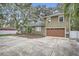 Two-story house with a large driveway and landscaped front yard at 734 S Mills Ave, Orlando, FL 32801