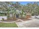 Two-story house with a large driveway and landscaped front yard at 734 S Mills Ave, Orlando, FL 32801