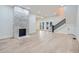 Spacious living room showcasing hardwood floors, a stone fireplace and access to back patio at 734 S Mills Ave, Orlando, FL 32801
