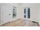 Hardwood floor bedroom with French doors and en-suite bathroom at 734 S Mills Ave, Orlando, FL 32801