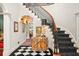 Elegant entryway with a curved staircase and checkerboard floor at 1391 Richmond Rd, Winter Park, FL 32789