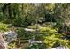 Landscaped backyard oasis with lush greenery and stone paths at 1391 Richmond Rd, Winter Park, FL 32789