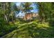 Brick house nestled in a lush, tree-filled backyard at 1391 Richmond Rd, Winter Park, FL 32789