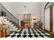 Elegant entryway with black and white checkered floor and staircase at 1391 Richmond Rd, Winter Park, FL 32789