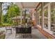 Brick covered patio with comfortable seating and French doors leading inside at 1391 Richmond Rd, Winter Park, FL 32789