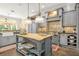 Gourmet kitchen boasts a large island, custom cabinetry, and high-end appliances at 1391 Richmond Rd, Winter Park, FL 32789