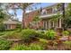 Brick house with balcony, lush landscaping, and a fountain at 1391 Richmond Rd, Winter Park, FL 32789