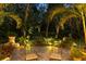 Evening view of backyard patio with fountain and comfortable seating at 1391 Richmond Rd, Winter Park, FL 32789