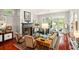 Sophisticated living room with hardwood floors, fireplace, and ample natural light at 1391 Richmond Rd, Winter Park, FL 32789