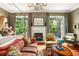 Spacious main bedroom with fireplace, sitting area, and access to private balcony at 1391 Richmond Rd, Winter Park, FL 32789