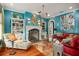 Living room with a turquoise accent wall, fireplace, and eclectic decor at 1391 Richmond Rd, Winter Park, FL 32789