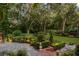Landscaped patio with brick walkways and garden lighting at 1391 Richmond Rd, Winter Park, FL 32789