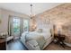King bedroom with brick feature wall and ensuite at 2602 Sunrise Shores Dr, Kissimmee, FL 34747