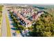 Aerial view showing townhouses, roads, and surrounding landscape at 2602 Sunrise Shores Dr, Kissimmee, FL 34747