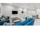 Open concept living room with modern furniture and a large TV at 2602 Sunrise Shores Dr, Kissimmee, FL 34747