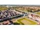 Aerial view of townhouses, roads, and surrounding green space at 2602 Sunrise Shores Dr, Kissimmee, FL 34747
