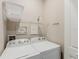 Laundry room with Whirlpool washer and dryer, shelving at 2602 Sunrise Shores Dr, Kissimmee, FL 34747