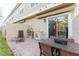 Brick paved patio with outdoor grill and seating area at 2602 Sunrise Shores Dr, Kissimmee, FL 34747