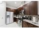 Modern kitchen with stainless steel appliances and granite countertops at 2602 Sunrise Shores Dr, Kissimmee, FL 34747