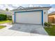 Two-car garage with a white door and blue trim at 6732 Westlake Blvd, Orlando, FL 32810