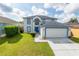 Two-story house with a two-car garage and landscaped lawn at 6732 Westlake Blvd, Orlando, FL 32810