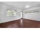 Spacious living room with wood-look floors and access to outdoors at 104 E Mcclendon St, Lady Lake, FL 32159