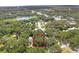 Aerial view showing a lot in a wooded area, near a road and other houses at 104 E Mcclendon St, Lady Lake, FL 32159