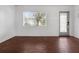 Bright living room with wood-look floors and a view to the backyard at 104 E Mcclendon St, Lady Lake, FL 32159