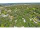 Aerial view of a residential area with green trees and houses at 104 E Mcclendon St, Lady Lake, FL 32159