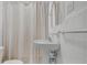 Clean bathroom with pedestal sink and shower at 104 E Mcclendon St, Lady Lake, FL 32159