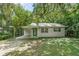 Cozy one-story house with a covered carport and green door at 104 E Mcclendon St, Lady Lake, FL 32159