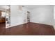 Open living room featuring wood-look floors and built-in shelving at 104 E Mcclendon St, Lady Lake, FL 32159