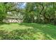 Large backyard with mature trees and lush grass at 104 E Mcclendon St, Lady Lake, FL 32159