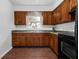 Updated kitchen with wood cabinets and black appliances at 104 E Mcclendon St, Lady Lake, FL 32159
