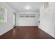 Bright living room with wood-look floors and access to backyard at 104 E Mcclendon St, Lady Lake, FL 32159