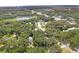 Aerial view showing the property's location near a lake and other buildings at 104 E Mcclendon St, Lady Lake, FL 32159