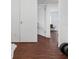 Clean hallway with wood-look floors and access to other rooms at 104 E Mcclendon St, Lady Lake, FL 32159