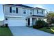 Two-story house with gray siding, white garage door, and landscaping at 2346 Upland Ln, Apopka, FL 32712