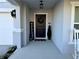 Front entrance with a dark door, welcome sign, and seasonal decor at 2346 Upland Ln, Apopka, FL 32712