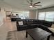 Spacious living room featuring a large sectional sofa and ceiling fan at 2346 Upland Ln, Apopka, FL 32712