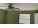 Well-lit bedroom featuring a window and ceiling fan at 7622 Forest City Rd # E, Orlando, FL 32810
