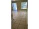 Living room with light beige tile flooring at 7622 Forest City Rd # E, Orlando, FL 32810