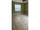 Bright bedroom with tile flooring and ceiling fan at 7622 Forest City Rd # E, Orlando, FL 32810